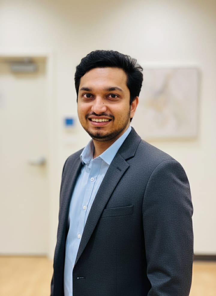 Portrait of Unnikrishnan T D smiling, wearing a charcoal blazer